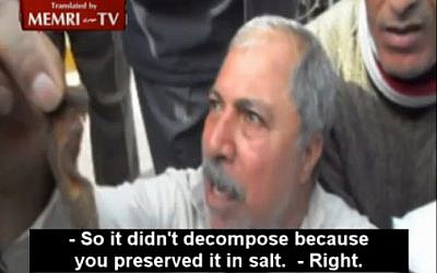 Egyptian protester Ibrahim Muhammad Ibrahim holds up what he claims is an ear he chopped of a dead Israeli officer during the 1973 war, during an anti Muslim Brotherhood protest in Cairo (photo credit: image capture/MEMRI)