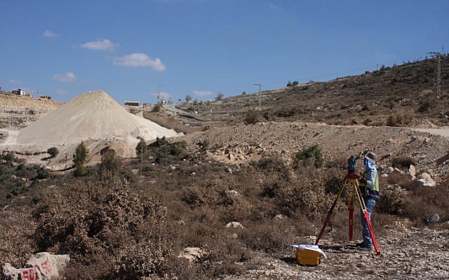 Surveyors take measurements of the road leading to the planned Palestinian city Rawabi in 2010 (photo credit: Issam Rimawi/Flash90) Surveyors take measurements of the road leading to the planned Palestinian city Rawabi in 2010 (photo credit: Issam Rimawi/Flash90)