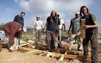 Illustrative: Settlers at the West Bank outpost of Oz Zion on December 30, 2012, following evacuation by security forces. (photo credit: Flash90)