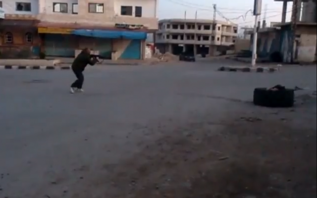 A rebel fighter engaged in battle Thursday in Khan Arnabeh (photo credit: screenshot/YouTube) A rebel fighter engaged in battle Thursday in Khan Arnabeh (photo credit: screenshot/YouTube)