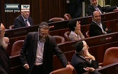 Moshe Gafni returning to his seat after angrily leaving the Knesset podium on Monday. (Screenshot: Knesset Channel)