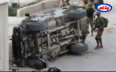 IDF soldiers inspect a jeep that was overturned in Bethlehem, on March 30, 2013. (image capture: YouTube)