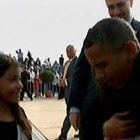 President Barack Obama hugs the daughters of US Ambassador to Israel Dan Shapiro, as Shapiro looks on, before he leaves Israel on Friday (photo credit: Channel 2 screenshot)