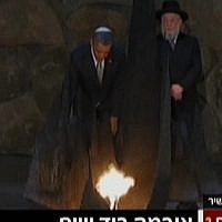 President Obama rekindles the 'eternal flame' at the Yad Vashem Holocaust Memorial Museum on Friday (photo credit: Channel 2 screenshot)
