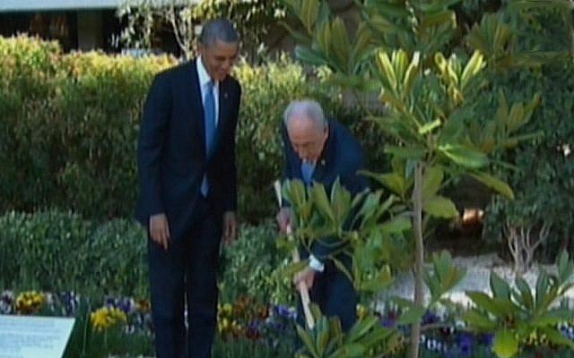 US President Barack Obama plants a tree at the President's Residence in Jerusalem with President Shimon Peres (photo credit: Channel 2)