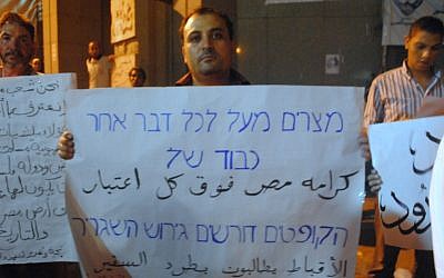 A Coptic protester holding a sign outside the Israeli Embassy in Beirut in 2011. (photo credit: CC BY lilianwagdy, Flickr)