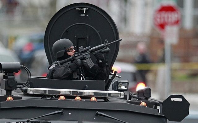 SWAT teams, bomb squads, and helicopters descend on Watertown, Massachusetts, which has remained on lockdown while officials try to locate the second Boston Marathon bomber, suspected to be Dzhokhar Tsarnaev. (photo credit: AP) SWAT teams, bomb squads, and helicopters descend on Watertown, Massachusetts, which has remained on lockdown while officials try to locate the second Boston Marathon bomber, suspected to be Dzhokhar Tsarnaev. (photo credit: AP)