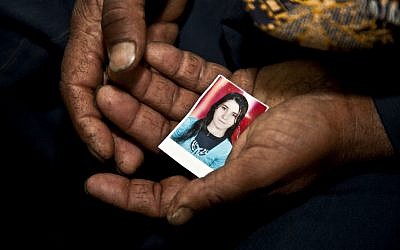 Christian farmer Ishaq Aziz cradles a picture of his daughter, 17-year-old schoolgirl, Nirmeen, who went missing on Valentine's Day and had not been seen or heard of since, in the Minya town of Matai, Egypt, March 27, 2013. (photo credit: AP/Thomas Hartwell)