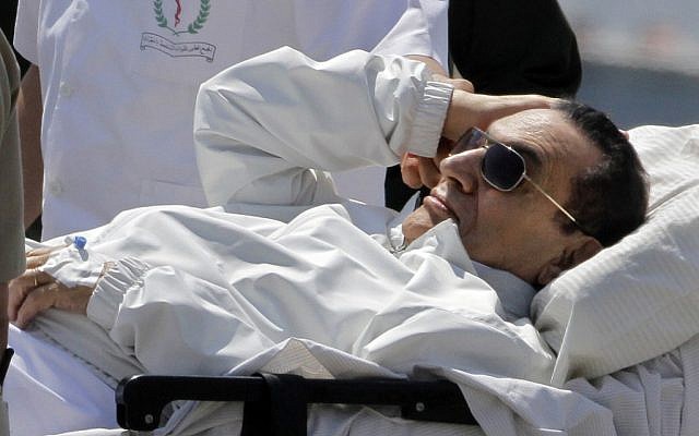 Egyptian medics and army personnel escort former Egyptian President Hosni Mubarak from a helicopter ambulance, after it landed at Maadi Military Hospital, following a hearing in his retrial in Cairo, Egypt, Saturday, on April 13, 2013. (photo credit: AP/Amr Nabil) Egyptian medics and army personnel escort former Egyptian President Hosni Mubarak from a helicopter ambulance, after it landed at Maadi Military Hospital, following a hearing in his retrial in Cairo, Egypt, Saturday, on April 13, 2013. (photo credit: AP/Amr Nabil)