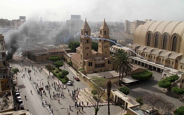 A tear gas canister is fired by Egyptian riot police into the compound of the Coptic Orthodox Cathedral after the funeral of four Christians killed in sectarian clashes near Cairo over the weekend in Cairo, Egypt, Sunday, April 7, 2013. (photo credit:AP/Mostafa El Shemy) A tear gas canister is fired by Egyptian riot police into the compound of the Coptic Orthodox Cathedral after the funeral of four Christians killed in sectarian clashes near Cairo over the weekend in Cairo, Egypt, Sunday, April 7, 2013. (photo credit:AP/Mostafa El Shemy)