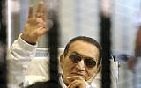 Former Egyptian President Hosni Mubarak waves to his supporters from behind bars as he attends a hearing in his retrial on appeal in Cairo, Egypt, Saturday, April 13, 2013 (photo credit: AP)