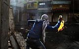 Illustrative photo of a young Palestinian hurling a firebomb in Hebron. (AP/Nasser Shiyoukhi)