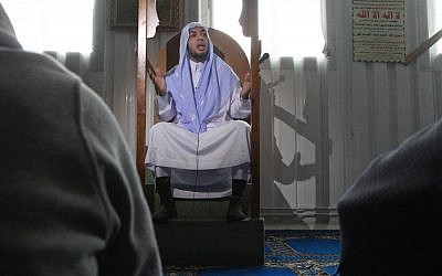 Imam Mohamed El Tamamy preaches at a mosque, in Brussels Friday, April 26 (photo credit: AP/Yves Logghe)