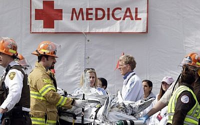Medical personnel work outside the medical tent in the aftermath of two blasts that exploded near the finish line of the Boston Marathon, Monday, April 15, 2013 (photo credit: AP/Elise Amendola)