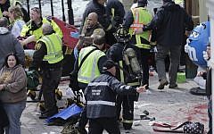 Medical workers aid injured people at the finish line of the 2013 Boston Marathon following an explosion in Boston on April 15, 2013 (AP/Charles Krupa)