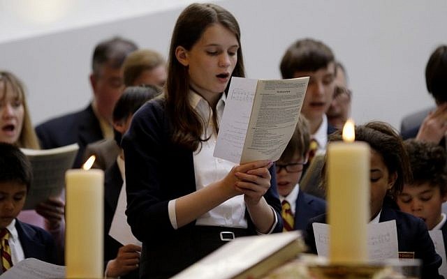 Annie Packard, 13, sings during Trinity Episcopal Church Sunday service at Temple Israel, which allowed the Trinity congregation to hold a service, Sunday. (photo credit: AP/Julio Cortez) Annie Packard, 13, sings during Trinity Episcopal Church Sunday service at Temple Israel, which allowed the Trinity congregation to hold a service, Sunday. (photo credit: AP/Julio Cortez)