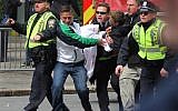 Emergency personnel carry a wounded person away from the scene of an explosion at the 2013 Boston Marathon in Boston on Monday. (photo credit: AP/Kenshin Okubo)
