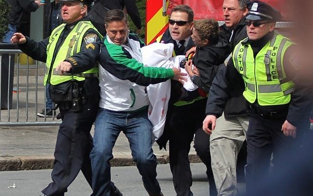Emergency personnel carry a wounded person away from the scene of an explosion at the 2013 Boston Marathon in Boston on Monday. (photo credit: AP/Kenshin Okubo) Emergency personnel carry a wounded person away from the scene of an explosion at the 2013 Boston Marathon in Boston on Monday. (photo credit: AP/Kenshin Okubo)