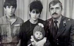 In this image taken from a video, an undated family photo provided by Patimat Suleimanova, the aunt of USA Boston bomb suspects, shows Anzor Tsarnaev left, Zubeidat Tsarnaev holding Tamerlan Tsarnaev and Anzor's brother Mukhammad Tsarnaev. Now known as the angry and grieving mother of the Boston Marathon bombing suspects, Zubeidat Tsarnaev is drawing increased attention after federal officials say Russian authorities intercepted her phone calls, including one in which she vaguely discussed jihad with her elder son. In another, she was recorded talking to someone in southern Russia who is under FBI investigation in an unrelated case, US officials said. (photo credit: AP/Patimat Suleimanova)