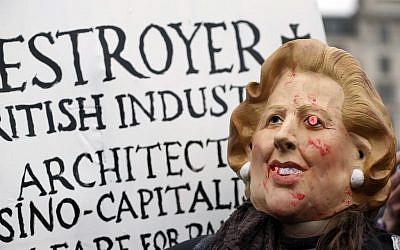 A protester wears a mask depicting former British Prime Minister Margaret Thatcher during a party to mark her death in central London's Trafalgar square, Saturday, April 13, 2013 (photo credit: AP/Lefteris Pitarakis)
