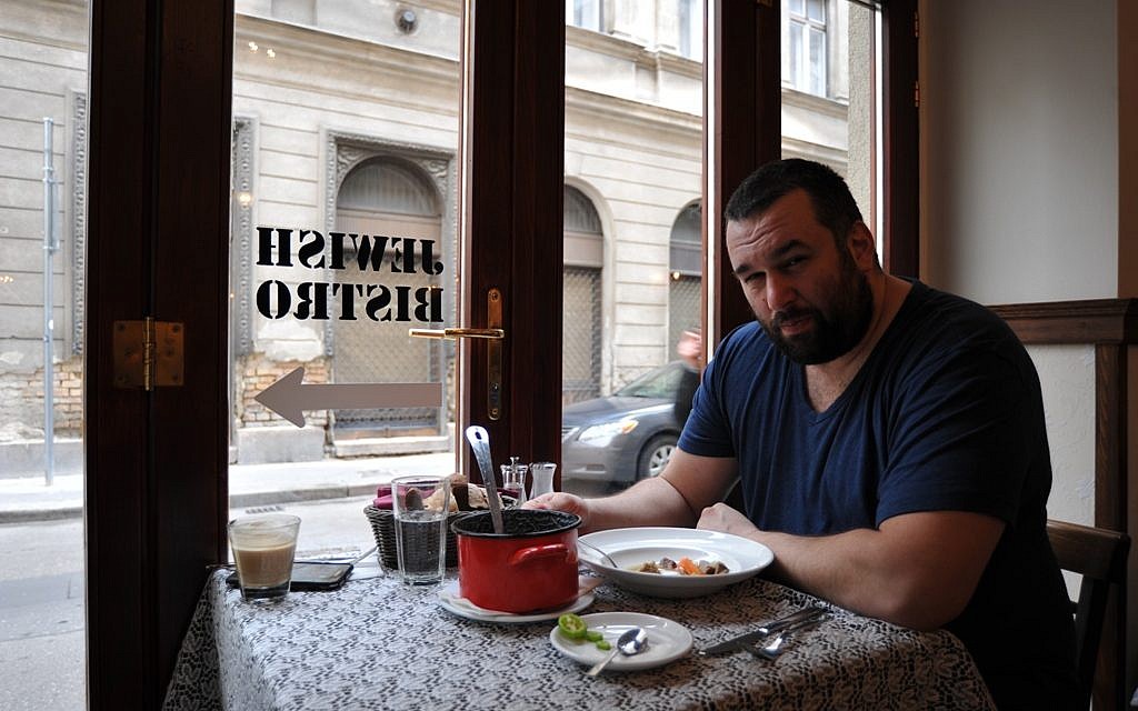 David Popovits, owner of the Matzah Soldier, sits down for a meal at his upscale restaurant in Budapest, March 2013. (photo credit: Cnaan Liphshiz/JTA) David Popovits, owner of the Matzah Soldier, sits down for a meal at his upscale restaurant in Budapest, March 2013. (photo credit: Cnaan Liphshiz/JTA)