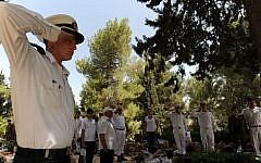 Soldiers and citizens standing near the graves of fallen IDF soldiers as the two-minute-siren marking Memorial Day is sounded across the country, in the military cemetery on Mount Herzl during Memorial Day in 2013 (photo credit: Gili Yaair/Flash90)