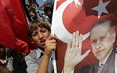 Palestinian students in Gaza hold up pictures of Recep Tayyip Erdoğan. (photo credit: Abed Rahim Khatib/Flash 90)
