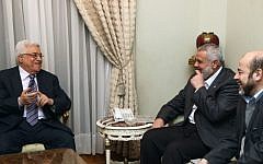 Palestinian Authority President Mahmoud Abbas (left) and Hamas Prime Minister Ismail Haniyeh (center) meeting in Cairo, on February 23, 2012 (photo credit: Mohammed Al-Hums/Flash90)