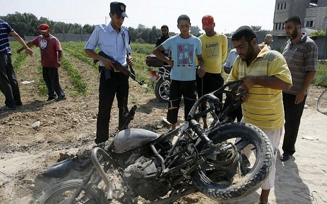 Palestinians inspect a motorcycle that was hit in a previous Israeli airstrike in the central Gaza Strip in 2012 (illustrative photo: Abed Rahim Khatib/Flash 90 Palestinians inspect a motorcycle that was hit in a previous Israeli airstrike in the central Gaza Strip in 2012 (illustrative photo: Abed Rahim Khatib/Flash 90