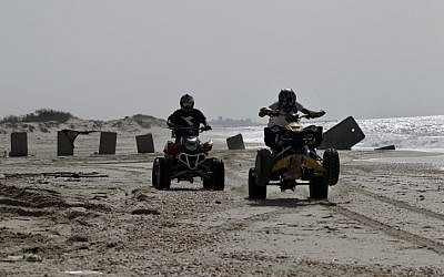 Israeli ATV riders on the beach (illustrative photo credit:  Tsafrir Abayov/Flash90)