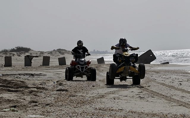 Israeli ATV riders on the beach (illustrative photo credit:  Tsafrir Abayov/Flash90)