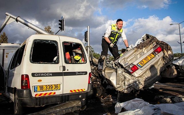 Rescue personnel at the site of a mass car crash that left 6 dead on a major Haifa road, Wednesday, April 10, 2013 (photo credit: Avishag Shaar Yashuv/Flash90) Rescue personnel at the site of a mass car crash that left 6 dead on a major Haifa road, Wednesday, April 10, 2013 (photo credit: Avishag Shaar Yashuv/Flash90)