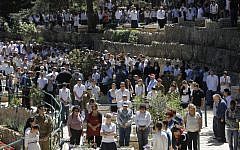 Israelis stand for two minutes of silence next to graves of fallen soldiers at the Mt. Herzl military cemetery in Jerusalem on Memorial Day, April 15, 2013. (photo credit: Miriam Alster/Flash90)