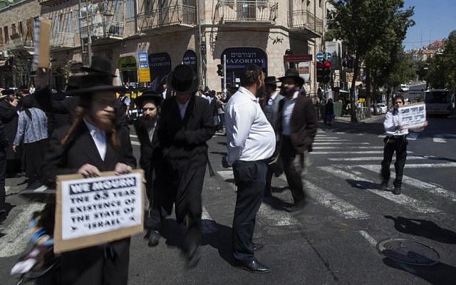 Anti-Zionist men marching during the two-minute siren on Monday morning. (photo credit: Yonatan Sindel/Flash90)