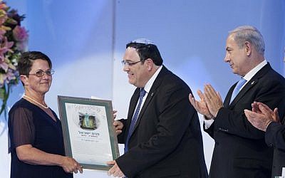 Ron Nachman's wife accepts her late husband's Israel Prize from Education Minister Shai Piron at the International Conference Center (ICC) in Jerusalem on April 16, 2013. (photo credit: Yonatan Sindel/Flash90)