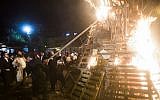 Ultra-Orthodox men set light to a massive bonfire during celebrations of the holiday of Lag B'Omer in Jerusalem on Saturday, April 27, 2013. (photo credit: Yonatan Sindel/Flash90)