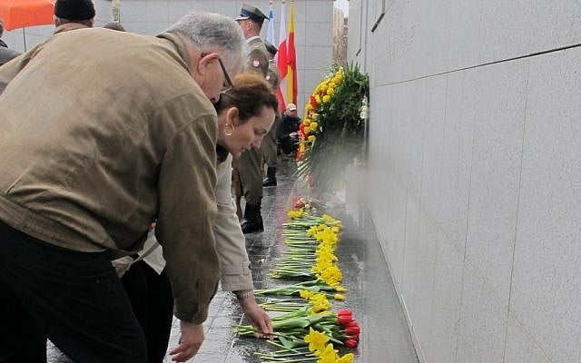 People laying flowers at Umschlagplatz in the Warsaw Ghetto at a monument on the site from which Jews were deported to Treblinka. (Ruth Ellen Gruber/JTA) People laying flowers at Umschlagplatz in the Warsaw Ghetto at a monument on the site from which Jews were deported to Treblinka. (Ruth Ellen Gruber/JTA)