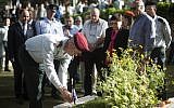 IDF Chief of Staff Benny Gantz putting an Israeli flag on the grave of a soldier at Mount Herzl,  April 10, 2013. (photo credit: Yonatan Sindel/Flash90)