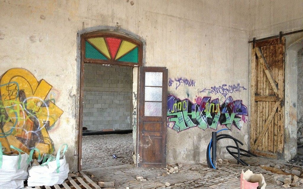A glimpse of the graffiti and crumbling walls that were inside the station (photo credit: Jessica Steinberg/Times of Israel)