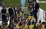 Maccabi Tel Aviv Team captain Shiran Yeini hoists the championship trophy before 33,000 delighted fans at Ramat Gan Stadium Monday, April 22 (image capture: Channel 5)