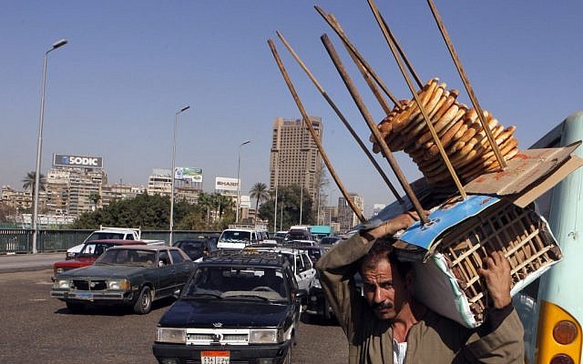 An Egyptian bread vendor looks for clients on a bridge over the Nile in Cairo. (photo credit: Amr Nabil/AP) An Egyptian bread vendor looks for clients on a bridge over the Nile in Cairo. (photo credit: Amr Nabil/AP)