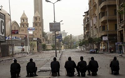Illustrative photo of Egyptian riot police watching over a Coptic cathedral in the early hours of Monday, April 8, 2013, in Cairo, Egypt. (photo credit: AP)