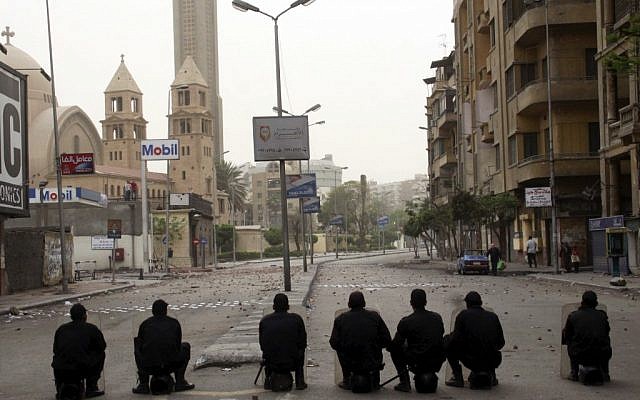Illustrative photo of Egyptian riot police watching over a Coptic cathedral in the early hours of Monday, April 8, 2013, in Cairo, Egypt. (photo credit: AP) Illustrative photo of Egyptian riot police watching over a Coptic cathedral in the early hours of Monday, April 8, 2013, in Cairo, Egypt. (photo credit: AP)