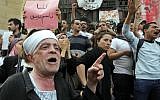 Egyptian activists shout anti-Muslim brotherhood slogans in front of Egypt's state prosecutors office in support of popular Egyptian television satirist Bassem Youssef, in Cairo, Egypt, Sunday, March 31, 2013.  (Photo credit: AP/Amr Nabil)