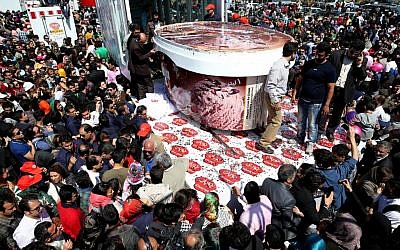 5-ton tub of ice-cream made by Iranian Choopan dairy is displayed during a ceremony at the Tochal mountainous area of northern Tehran, Iran, Monday, April 1 (photo credit: AP/Ebrahim Noroozi)
