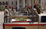 Security forces escort the coffins of five slain soldiers at the headquarters of the Iraqi Ministry of Defense in Baghdad, Iraq, Sunday, April 28, 2012. Gunmen killed 10 people in Iraq, including five soldiers near the main Sunni protest camp west of Baghdad on Saturday, the latest in a wave of violence that has raised fears the country faces a new round of sectarian bloodshed. (Photo credit: AP/Hadi Mizban)