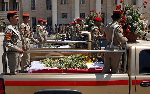 Security forces at the headquarters of the Iraqi Ministry of Defense in Baghdad, Iraq, escort the coffins of five soldiers slain in sectarian violence, Sunday, April 28, 2013. (photo credit: AP/Hadi Mizban) Security forces at the headquarters of the Iraqi Ministry of Defense in Baghdad, Iraq, escort the coffins of five soldiers slain in sectarian violence, Sunday, April 28, 2013. (photo credit: AP/Hadi Mizban)