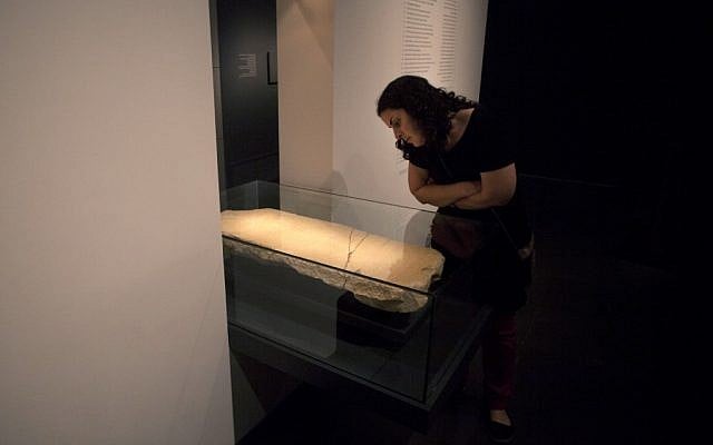 A museum worker looks at the 'Gabriel Stone' as it is displayed at the Israel Museum in Jerusalem, Tuesday, April 30, 2013. (photo credit: AP/Sebastian Scheiner) A museum worker looks at the 'Gabriel Stone' as it is displayed at the Israel Museum in Jerusalem, Tuesday, April 30, 2013. (photo credit: AP/Sebastian Scheiner)