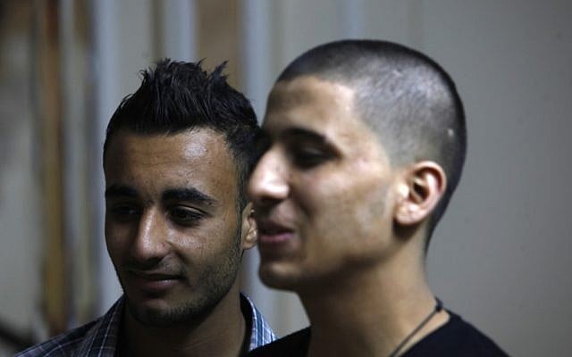Ayman al-Sayed, 19, right, with his hair cut, stands with his friend Mohammed Hanouna, 18, left, in Gaza City, Sunday, April 7, 2013. Al-Sayed used to have shoulder-length hair but says he was grabbed by Hamas police in a sweep along with other young men with long or gel-styled spiky hair last week, and that police shaved everyone's head. Hanouna still wears the hair-style that can now get young men in trouble in Gaza, during the Islamic militants latest attempt to impose their hardline version of Islam on Gaza. (photo credit: AP/Adel Hana) Ayman al-Sayed, 19, right, with his hair cut, stands with his friend Mohammed Hanouna, 18, left, in Gaza City, Sunday, April 7, 2013. Al-Sayed used to have shoulder-length hair but says he was grabbed by Hamas police in a sweep along with other young men with long or gel-styled spiky hair last week, and that police shaved everyone's head. Hanouna still wears the hair-style that can now get young men in trouble in Gaza, during the Islamic militants latest attempt to impose their hardline version of Islam on Gaza. (photo credit: AP/Adel Hana)