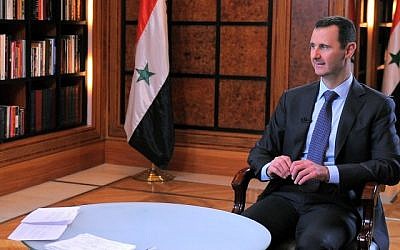 Bashar Assad, right, during an interview broadcast on Syrian state television in Damascus, Syria last month. (photo credit: AP/SANA)
